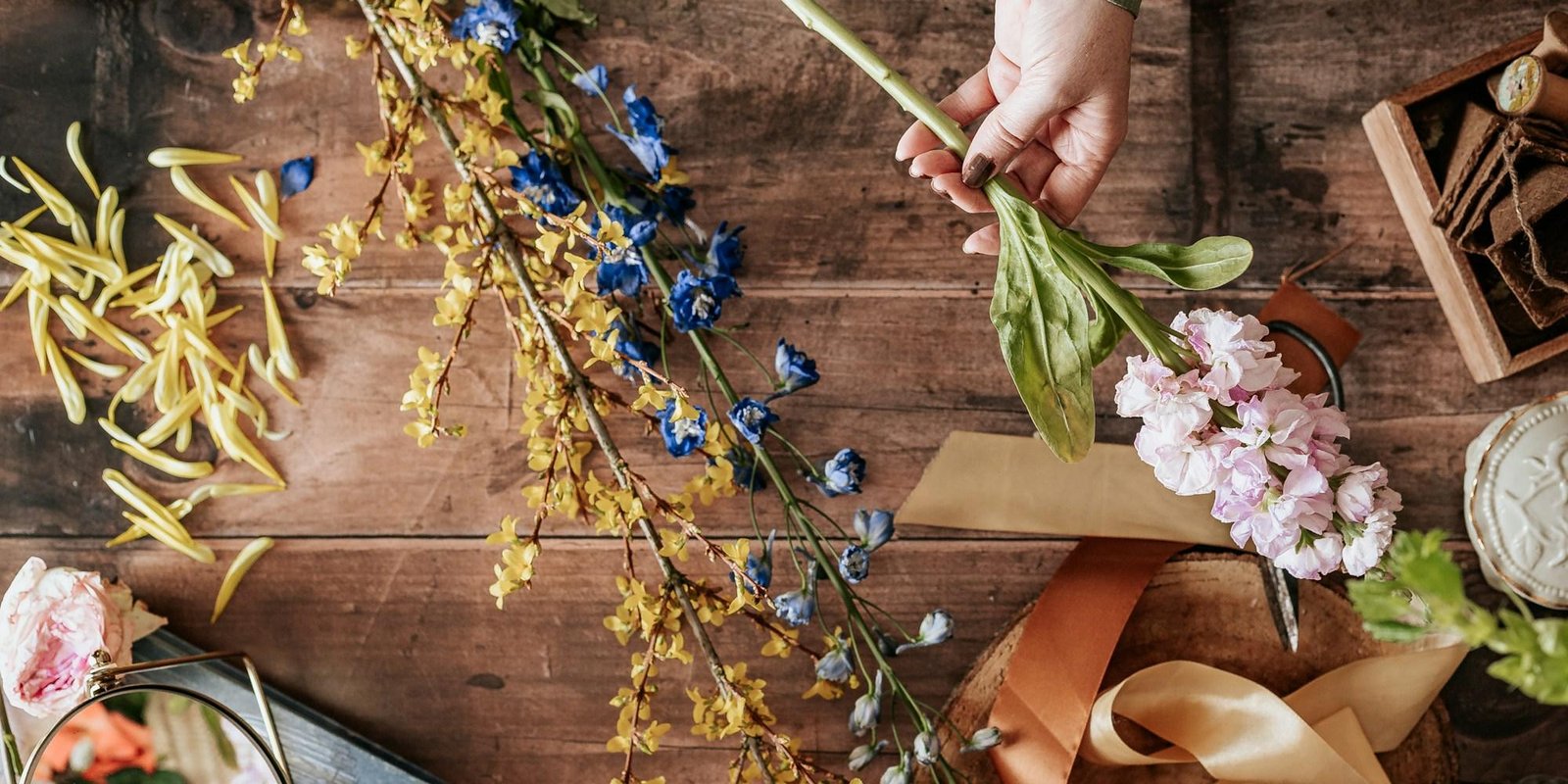 Hands arranging flowers during a wedding build