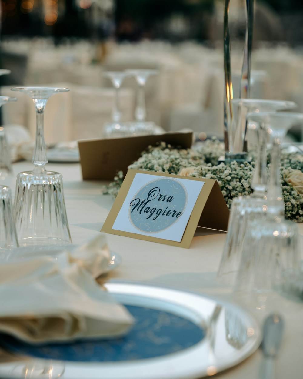 Place cards and glassware on a dressed table