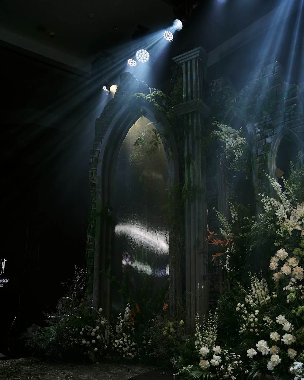 A mirrored archway dressed in white flowers