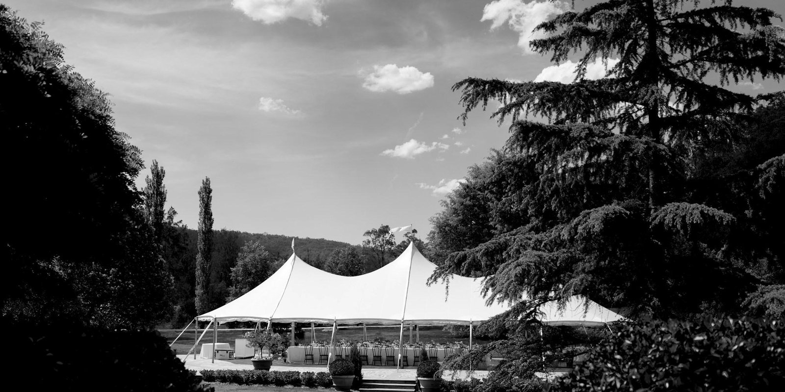 A marquee going up in an empty field before a wedding
